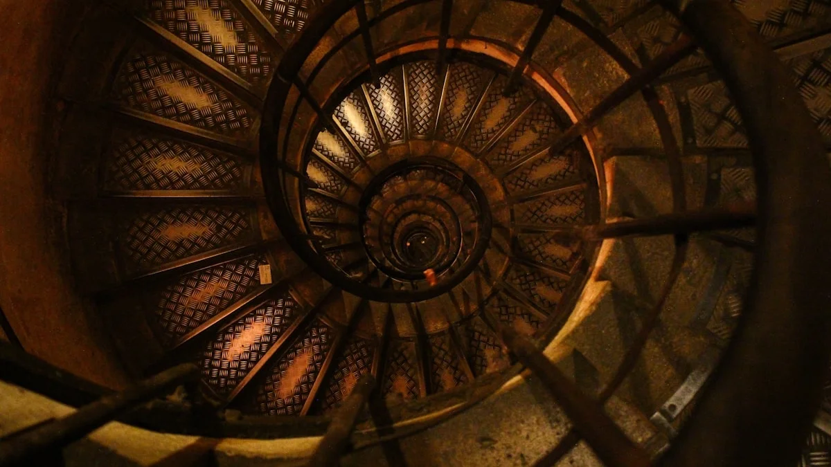 A worn spiral staircase winds down into warm orange lamplight. — a The Obsidian Key guide to Advanced Discernment for Practitioners Who Keep the Key.