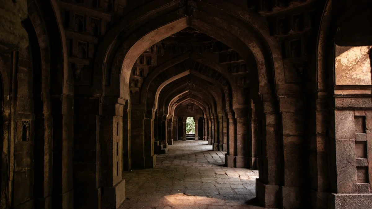 A dark stone corridor of arches ends in a single doorway of light. — a The Obsidian Key guide to Deep Focus as Ritual: Guarding the First Hour.