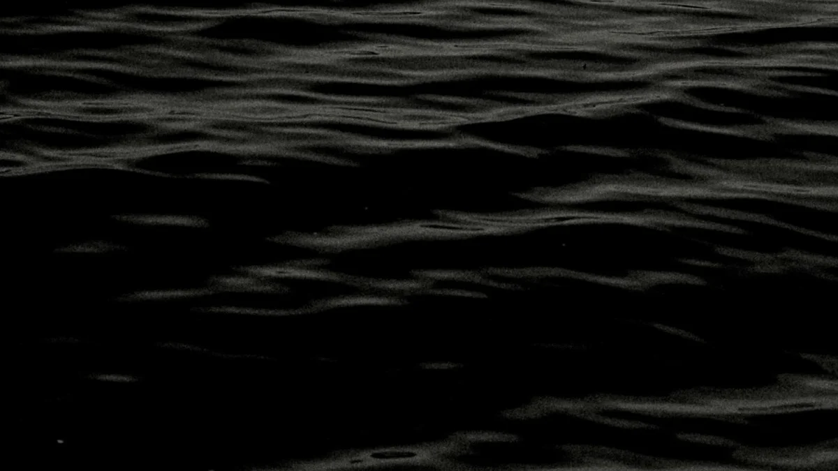 A dark water surface with slow, faint ripples at night. — a The Obsidian Key guide to The Five Leaks Draining Your Attention.
