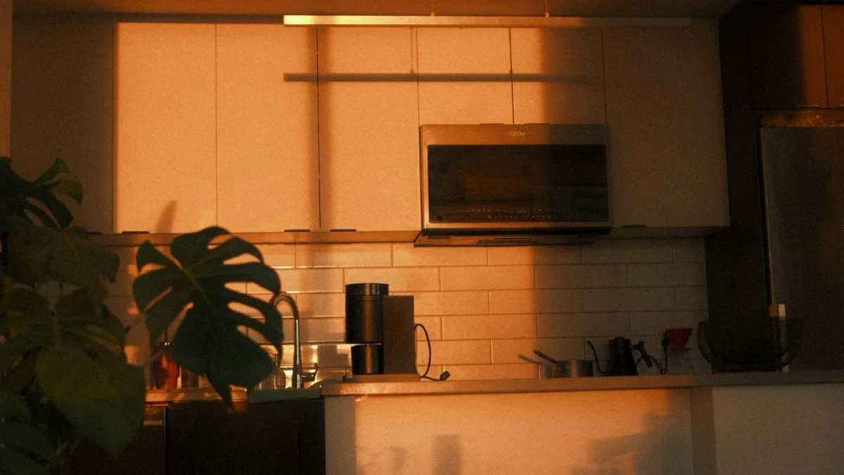 Warm sunset light washes over a quiet apartment kitchen with a single empty stool. — a The Obsidian Key guide to Guilt Urgency and Borrowed Moods at Home.