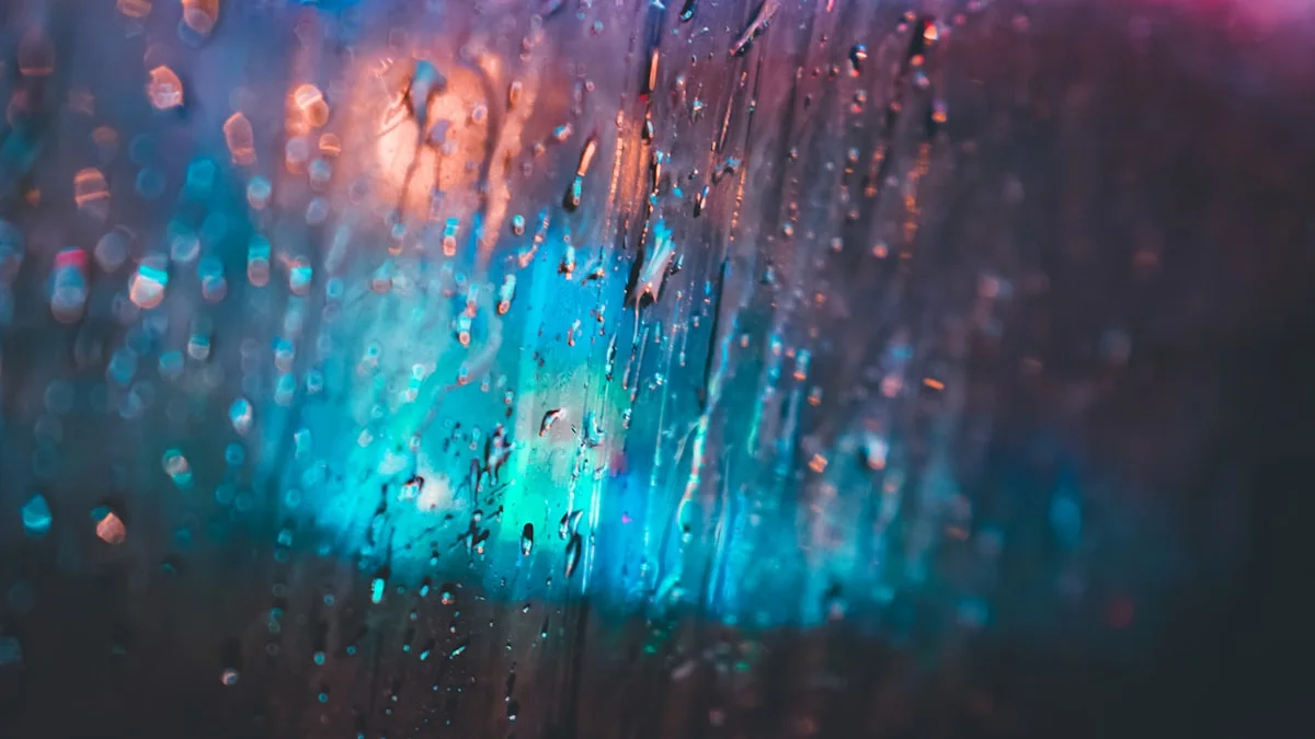 Rain beads on a dark window with blurred city lights glowing behind the glass at night. — a The Obsidian Key guide to Revenge Bedtime Procrastination Is an Open Circuit.