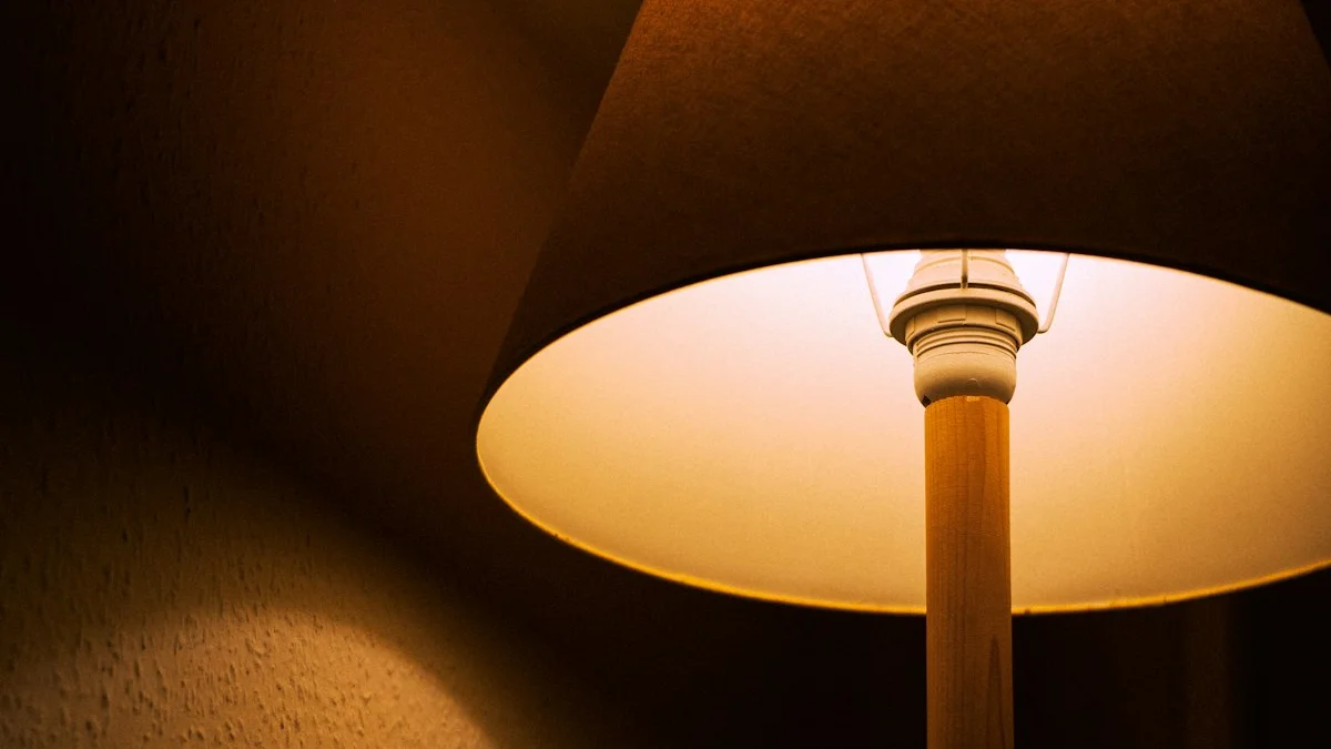 A warm amber lampshade glows in a dark room, casting low light on the wall. — a The Obsidian Key guide to Night Shifts and Early Shifts: Moving the Ritual Hour.