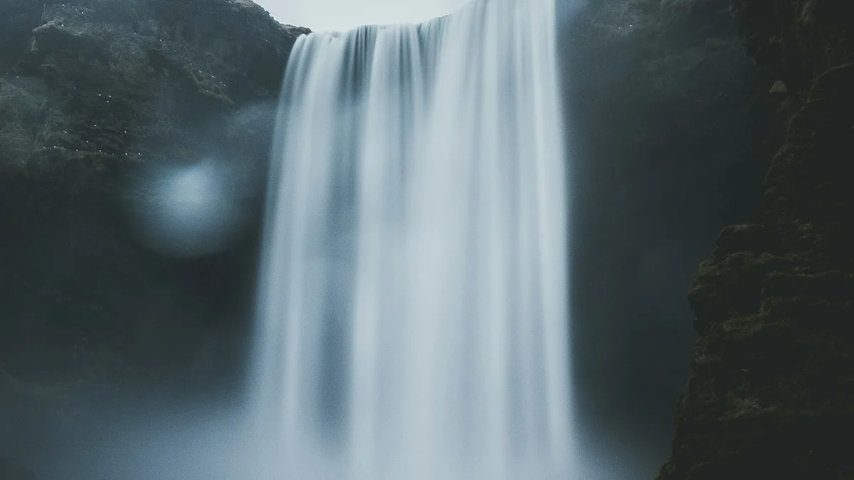 A long-exposure waterfall pours in one unbroken silver stream between dark cliffs. — a The Obsidian Key guide to A Scattered Hour Is Worth Less Than a Focused Minute.