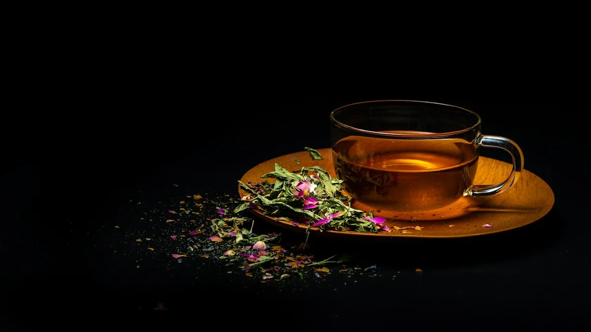 A clear glass cup of amber tea rests on a wooden plate with scattered tea leaves against darkness. — a The Obsidian Key guide to The Sealed Tongue and Your Partner.