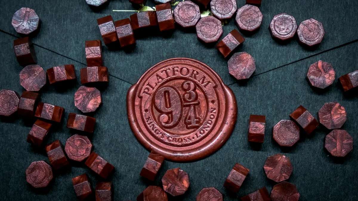 Red wax seal stamped on a dark green envelope surrounded by sealing-wax beads. — a The Obsidian Key guide to Why Beginners Stay Quiet About Results.