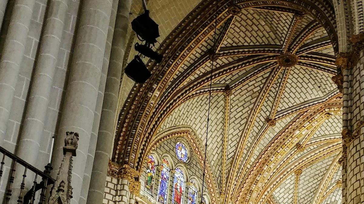 Golden vaulted ceilings and stained glass windows rise inside an ornate cathedral. — a The Obsidian Key guide to The Silent Center: Reading the Book's Stillness Chapter.