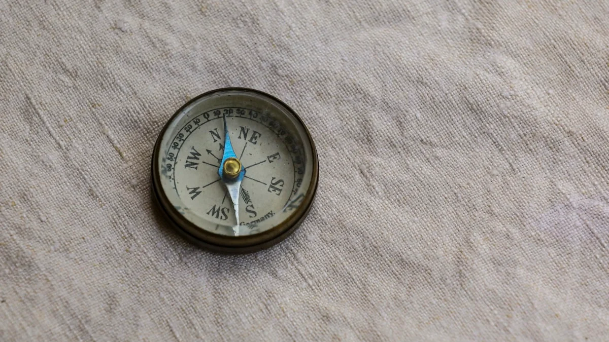 A small brass compass rests on soft grey linen, its needle steady. — a The Obsidian Key guide to Stillness Self-Check: Reaction Speed, Sleep, and the Hand.