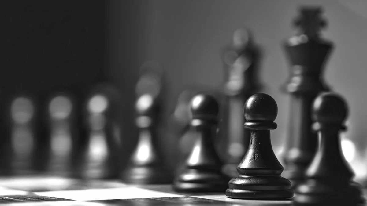 Black chess pieces lined up in shallow focus across a chessboard. — a The Obsidian Key guide to The Obsidian Key Review: Who This Book Serves.