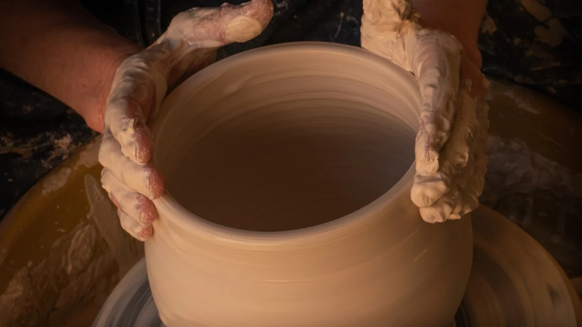 Two hands cradle a freshly thrown clay vessel in warm workshop light. — a The Obsidian Key guide to The Receiving Rule: Accept Without the Disclaimer.