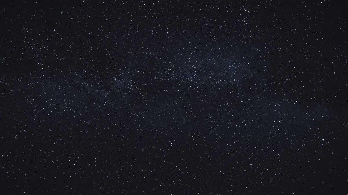 A dark night sky scattered with stars and a faint Milky Way band. — a The Obsidian Key guide to The Veil for Beginners: The Installed Story.