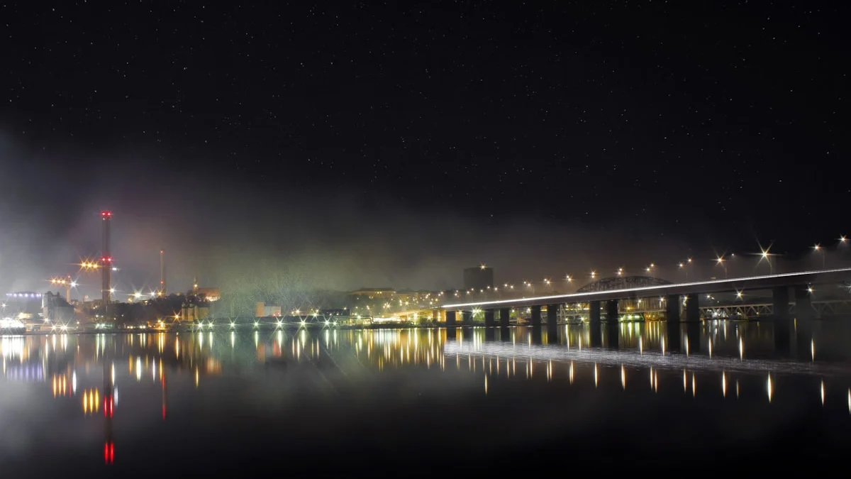 A long bridge crosses still water at night, its lights reflected in the dark surface. — a The Obsidian Key guide to Does the Thirty-Day Path Work: An Honest Review.