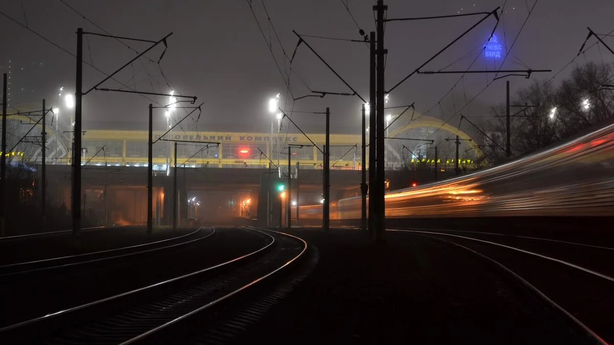Tangled overhead wires cross a foggy rail yard as a train blurs past at night. — a The Obsidian Key guide to What a Dysregulated Receiver Does to Your Broadcast.